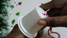 Thread beads through yogurt cup